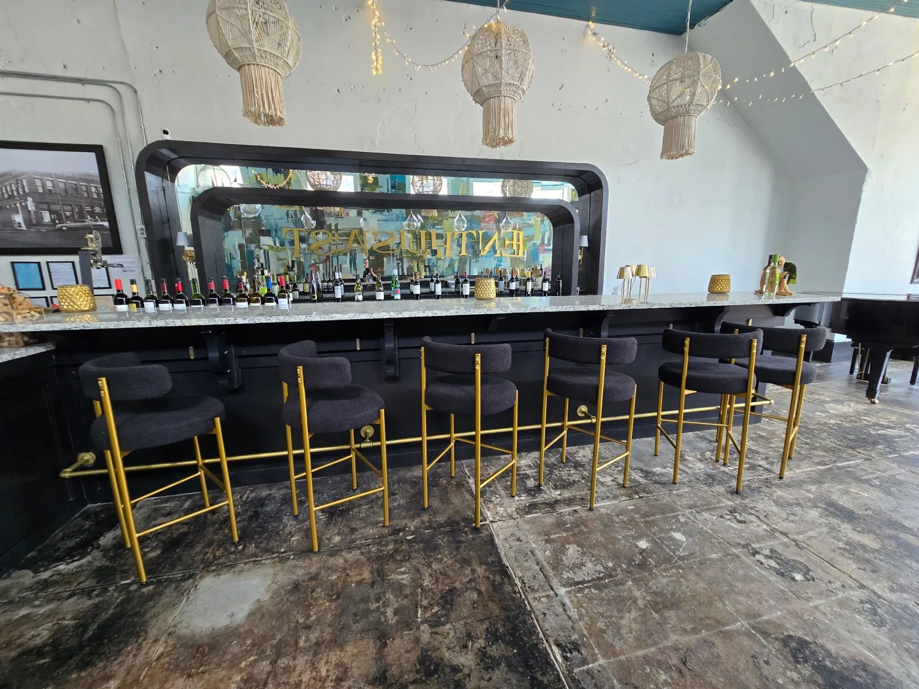 Completed Wine Bar with a mirrored back bar, bottles, and gold bar stools