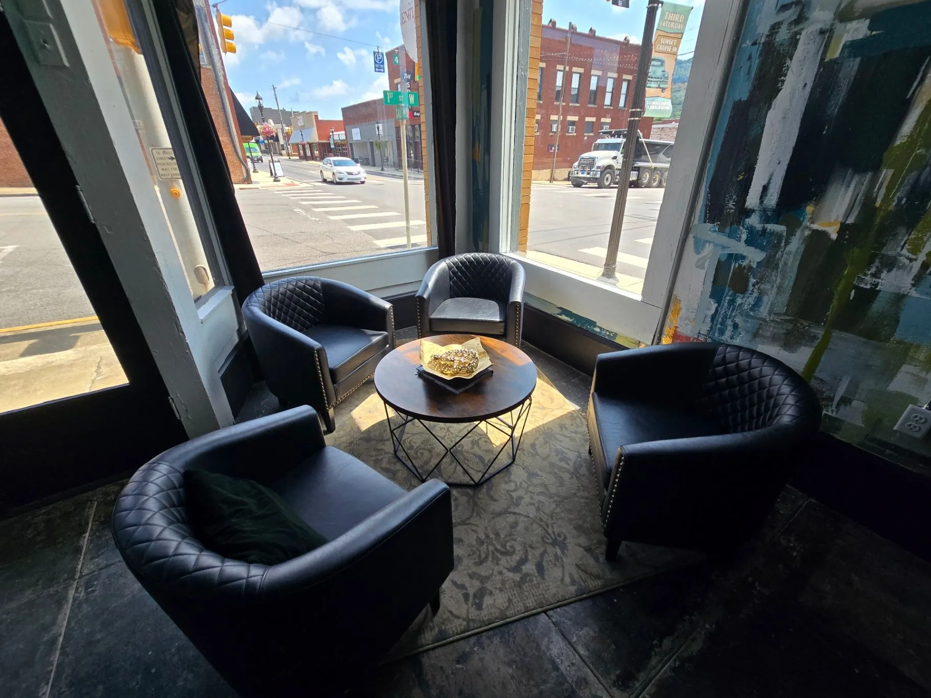 Completed Wine Bar lounge seating with black leather chairs and a round table